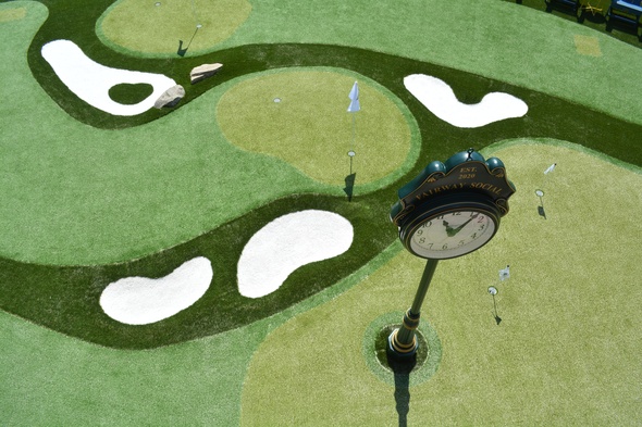 Charlotte Synthetic grass golf course with sand traps and golfers